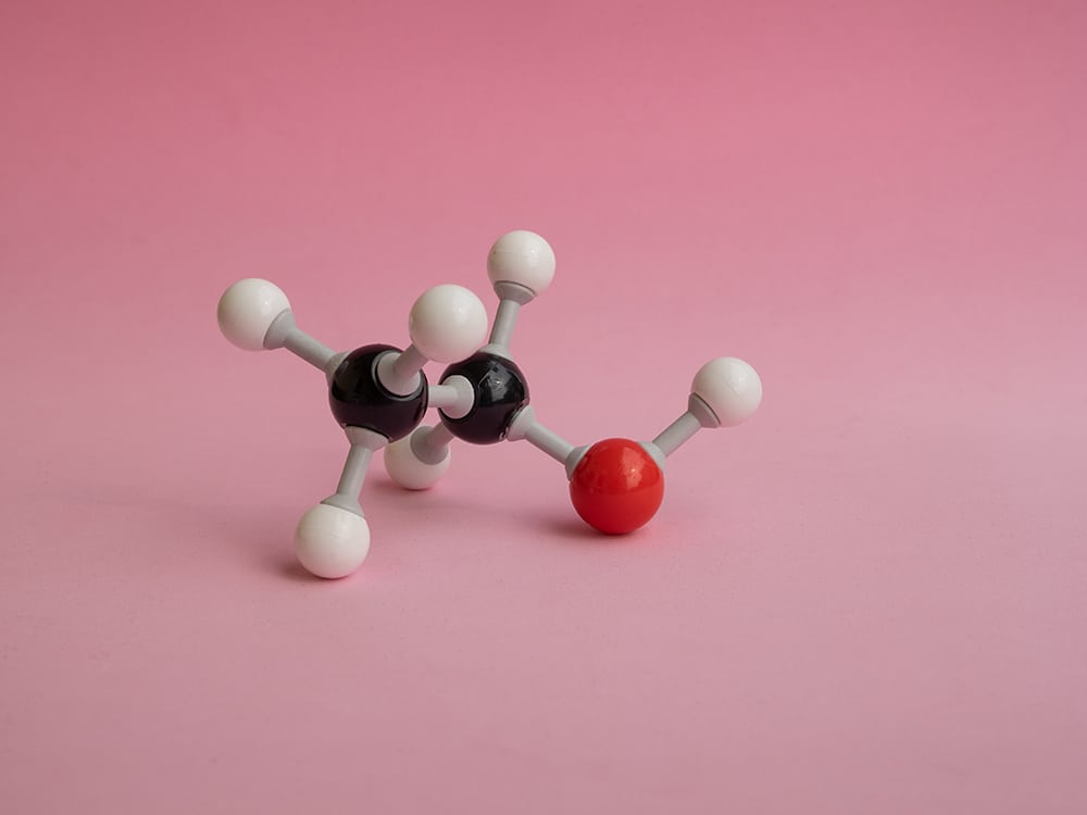 Molecular atom model isolated on a pink background